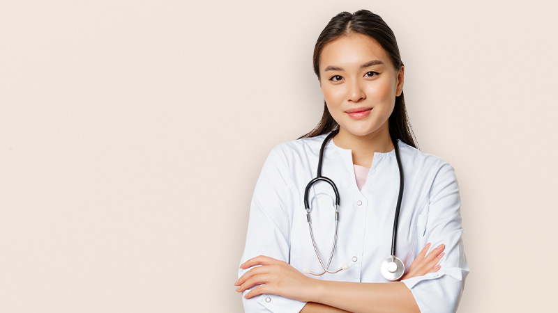 A doctor in a white coat with a stethoscope around her neck