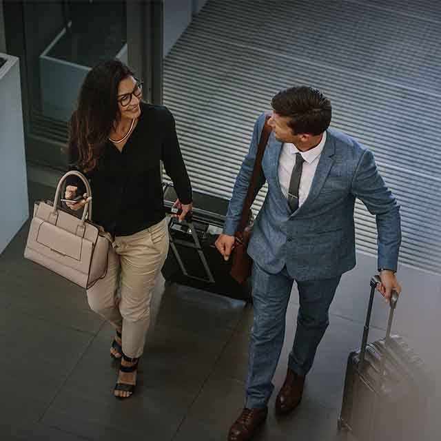 A man and a woman with their luggage in the airport